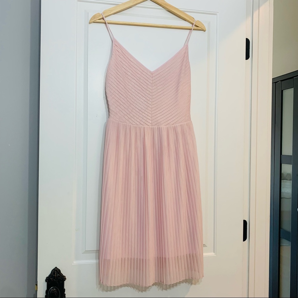 Baby pink pleated cocktail dress.